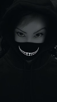 a woman in a black hoodie with a smile on her face